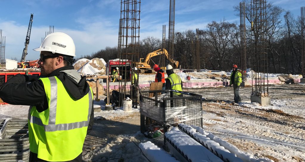 Joe Procunier observing construction progress at a job site.